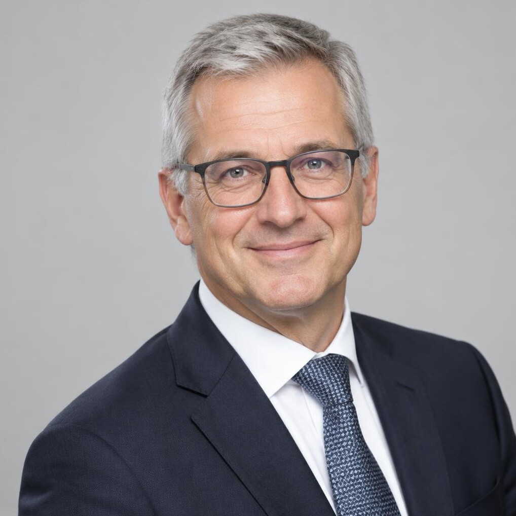 Studio portrait of a Caucasian man in his 50s wearing glasses